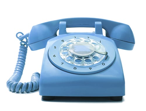 Old-fashioned blue telephone on a white background.