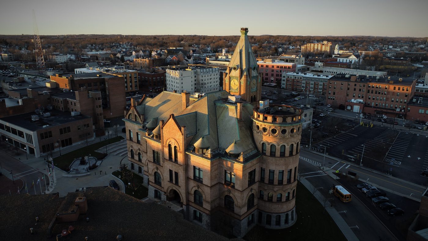 Drone imagery of Brockton City Hall at sunset.